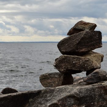 This photo was taken in October 2021 on the shore of Lake Nipissing. Along the shoreline at the North Bay Waterfront is made up of rocky sections and beautiful beaches. These inuksuks line the shoreli ...