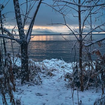 First snowfall of 2021/2022 winter season. Early morning as the sun was rising over Lake Simcoe at Kitchener Park in Orillia, Ontario.