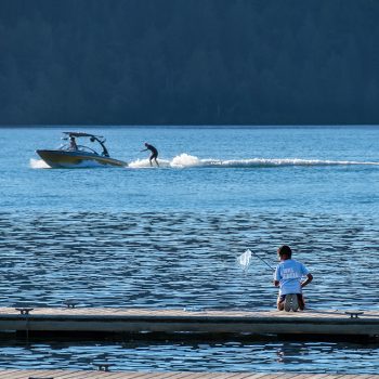 Early Evening on Cultus lake. One of the last of the waterskiers, and a boy enjoying the wonders of a lake.