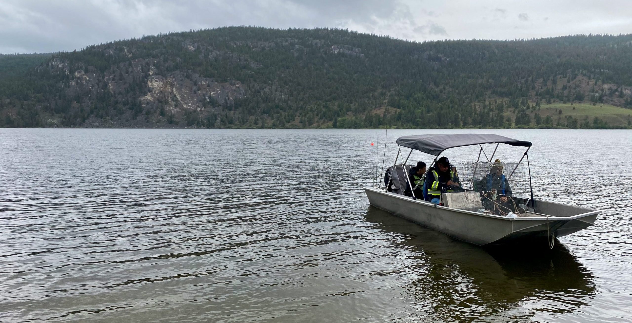 Living Lakes Canada team on a boat visiting visits the traditional territory of the Upper Nicola Band.