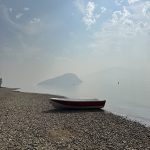 A kayak on the shore of Shushwap Lake on a sunny misty day.