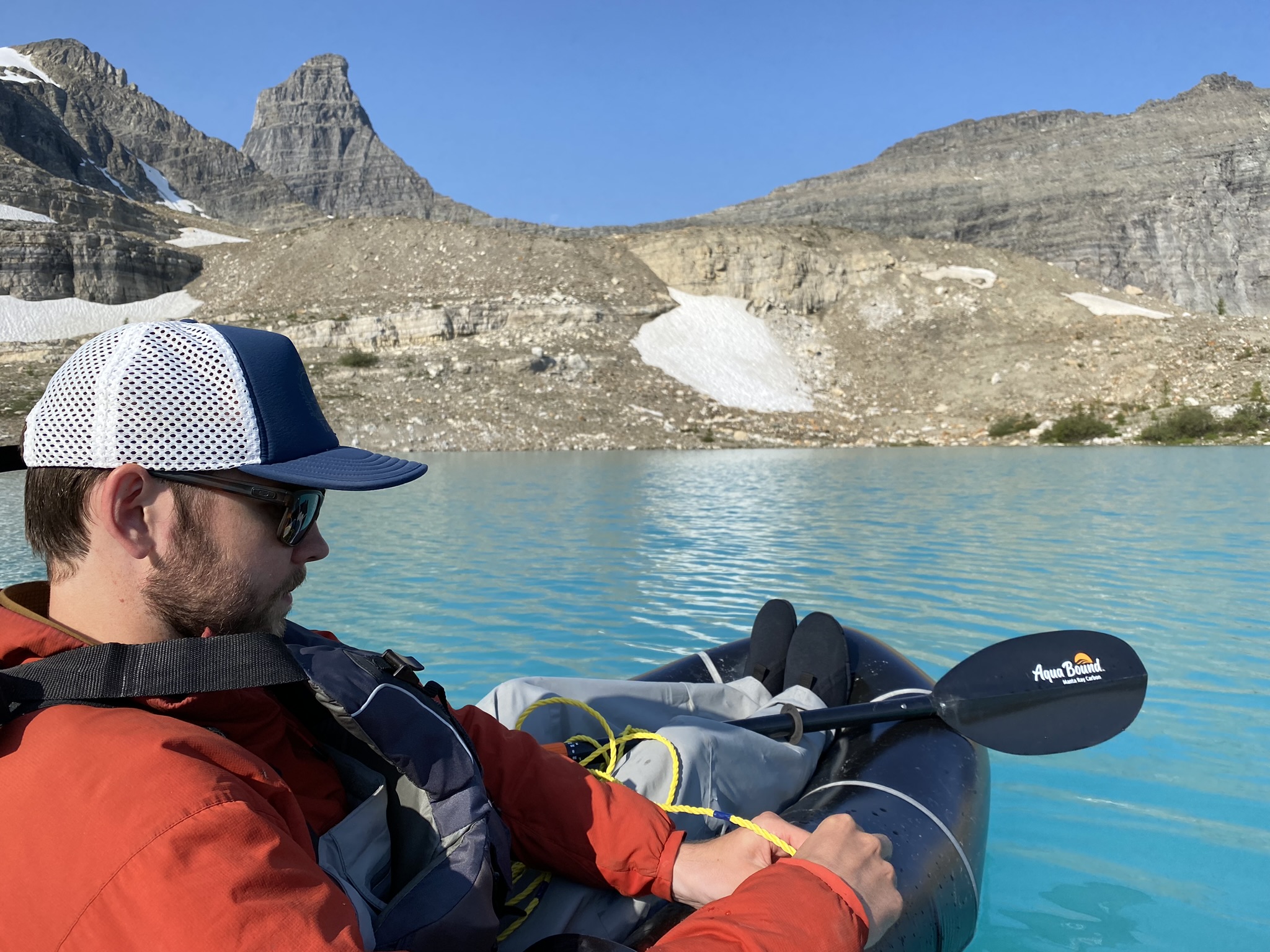 A man on an inflatable boat taking water samples on Talus Lake.