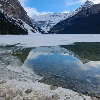 beautiful view of Moraine Lake with the reflection of the mountains in the water.