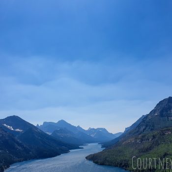 Upper Waterton Lake showcased between a valley in the mountains.