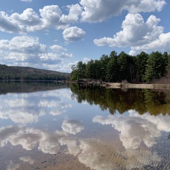 A peaceful summer day before the camping season began. The water was like glass. The sky was perfectly reflected. It was a moment of peace before the business of life began again.