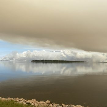 Photo taken Monday May 29, 2023. Lots of new forest fires starting up across the lake. A huge dark smoke and ash cloud formed. With the reflection in the water it made the whole scene seem surreal.