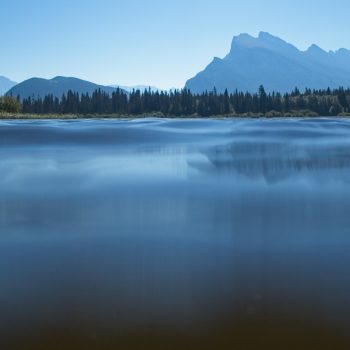 An over/under shot taken with my waterproof camera, which explains why there's not the expected reflection of Mt Rundle. This was taken while kayaking.