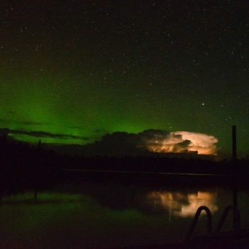 A thunderstorm with lighting in the clouds to the north. The northern lights were also out dancing.