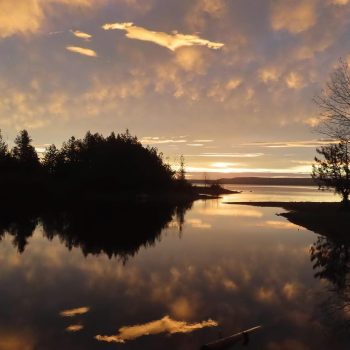 Sunrise over Georgian Bay, with a cloud formation creating a dappled sky and reflection.