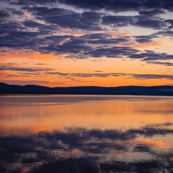 A beautiful sunset during my trip to Algonquin Park. The peacefulness of the lake is causing a glass effect which is creating a beautiful reflection.