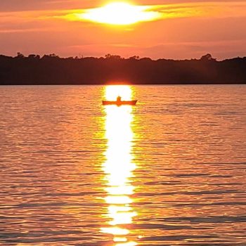 Beautiful sunset with canoe.