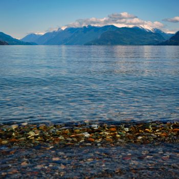 A placid breaking wave on the quiet Lake Harrison shoreline.