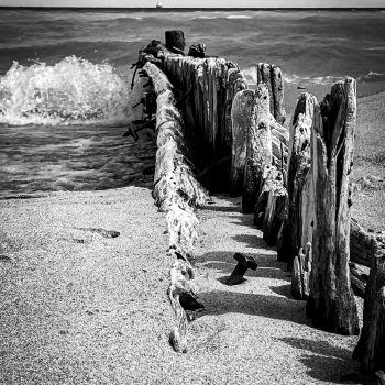 History unveiled by the storm. The groynes create wonder about builders, beach goers, seasons and storms of the past.