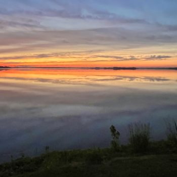 Smokestacks & Silhouettes at Sunrise.

Looking east across Hay Bay as a new day dawns, the smokestacks of a nearby gas-fueled power generating station sit quietly while vegetation in the foregro ...