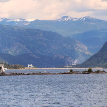 Lower Arrow Lake with marina in foreground, Hugh Keenleyside Dam and Zellstoff Celgar Pulp Mill in background.