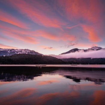 Pre dawn clouds lit by the underglow, reflecting off the still lake.