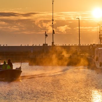 Early morning fog lifting as Gimli fishers return from emptying their nets.