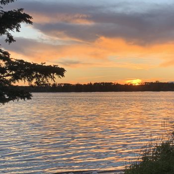 Sunset over the lake and thru the trees.