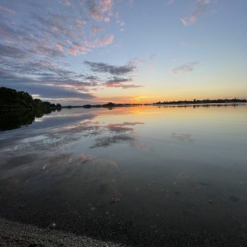 Beautiful reflection on the lake of color and clouds. Watching the sunset at the Saltcoats Regional Park swimming area.